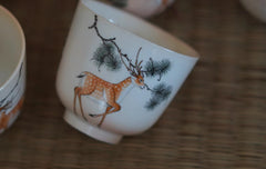 Hand made and hand painted woodfired sika deer and pine tree cup