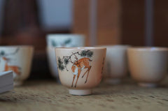 Hand made and hand painted woodfired sika deer and pine tree cup