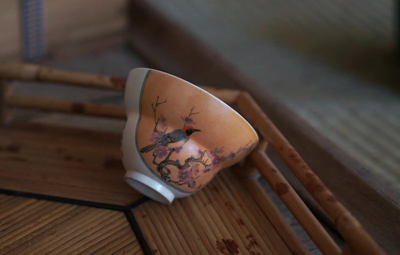 Handmade and hand painted wood fired bird and plum blossom cup